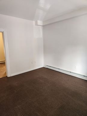Lancaster apartment for rent - A room with brown carpet and white walls.