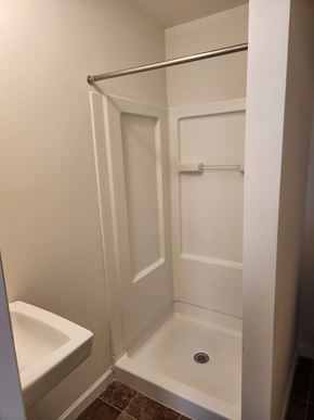 Lancaster apartment for rent - A white bathroom with a toilet and a walk in shower.
