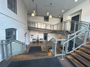 Lancaster apartment for rent - A staircase with a metal railing and a black mat on the floor.