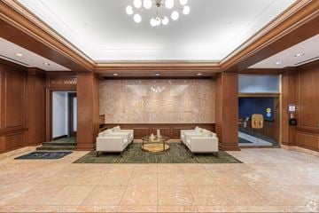 Lancaster apartment for rent - A spacious lobby with a marble floor and a chandelier hanging from the ceiling.