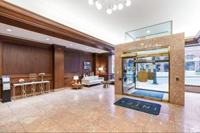 Lancaster apartment for rent - A hotel lobby with a blue carpet and a glass door.