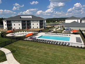 Shepherdsville townhouse for rent - A large building with a pool in front of it.
