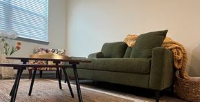 Shepherdsville townhouse for rent - A green couch with a brown table in front of it.