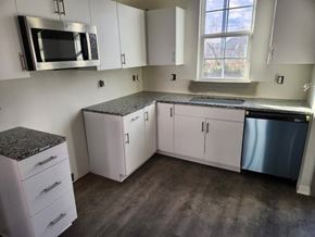 Shepherdsville townhouse for rent - A kitchen with white cabinets and a granite countertop.