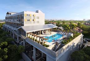 Miami apartment for rent - a hotel with a swimming pool and a building with palm trees