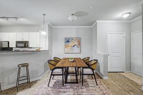 Richmond Hill apartment for rent - A dining room with a wooden table and chairs.