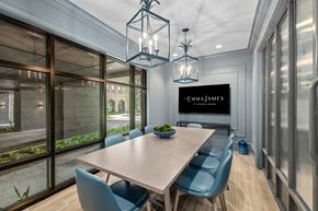 Savannah townhouse for rent - A dining room with a table and chairs and a sign that says Emma James.