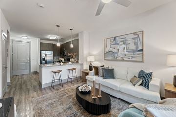 San Antonio apartment for rent - A modern living room with a bar area and a painting on the wall.