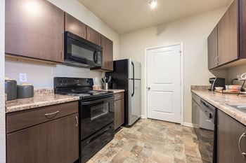 Kitchen with a black refrigerator