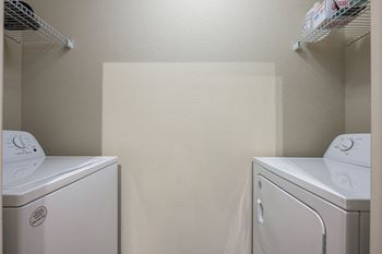 Two white front loading washing machines 
