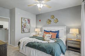 Richmond Hill apartment for rent - A bedroom with a bed, nightstands, and a ceiling fan.