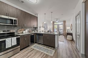 San Antonio apartment for rent - A modern kitchen with dark wood cabinets and stainless steel appliances.