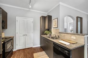 Ladson apartment for rent - A kitchen with a black oven and a white door.at Cypress River, Ladson