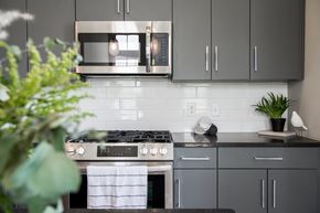 Savannah townhouse for rent - A modern kitchen with a stove top oven and a microwave above it.