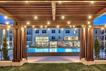 Pool surrounded by wooden pergola
