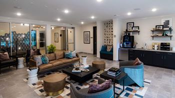 A living room with a brown couch, a coffee table, and a blue chair