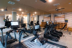 Wilmington apartment for rent - A gym with a variety of exercise equipment including treadmills and stationary bikes at Hudson at Renaissance Apartments, Wilmington, NC 28405