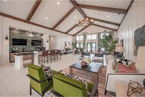 Simpsonville townhouse for rent - A modern living room with a stone fireplace and a large green sofa at Waterleaf at Neely Ferry Apartments, Simpsonville, South Carolina