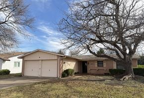 Dallas apartment for rent - A house with a tree in front of it.