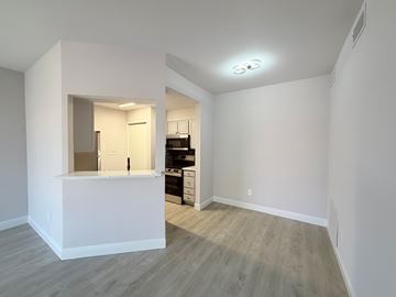 Dallas condo for rent - A kitchen area with a counter and cabinets is visible through a window.