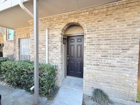 Dallas condo for rent - A house with a brown door and a grey wall.