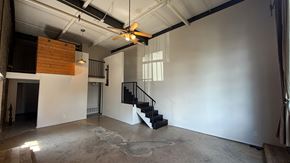 Dallas apartment for rent - A room with a staircase and a ceiling fan.