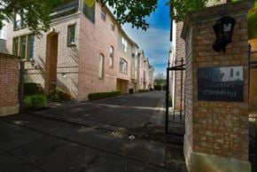 Dallas townhouse for rent - A brick building with a sign that says Charles Landing.