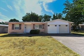 Dallas apartment for rent - A house with a white garage door and brown trim.