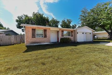 Dallas apartment for rent - A house with a brown brick exterior and a white garage door.