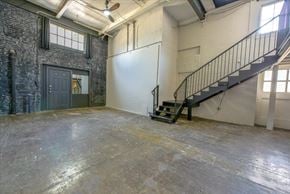 Dallas apartment for rent - A room with a concrete floor and a staircase.
