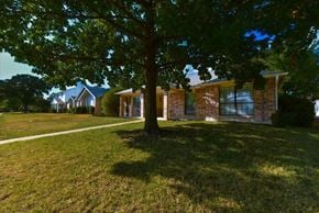 Garland apartment for rent - A house with a tree in front of it.