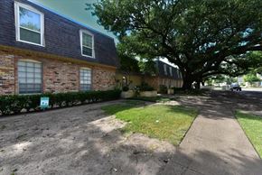 Dallas condo for rent - A brick house with a sign in front of it.