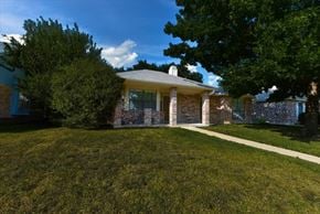 Garland apartment for rent - A house with a well-manicured lawn in front.
