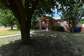 Dallas apartment for rent - A tree in front of a house.