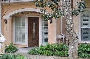 Dallas condo for rent - A house with a brown door and white shutters.