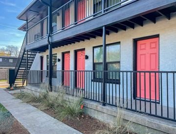 Dallas apartment for rent - a building with a red door and a staircase