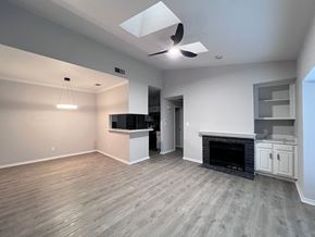 Dallas apartment for rent - A living room with a fireplace and a television.