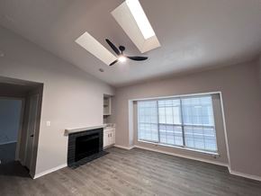 Dallas apartment for rent - A room with a fireplace and a window with blinds.