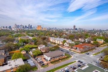 Dallas apartment for rent - A cityscape with a mix of residential and commercial buildings, with a clear sky above.