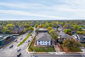 Dallas apartment for rent - A view of a street with cars and houses.