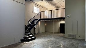 Dallas apartment for rent - A large empty room with a staircase and a window.