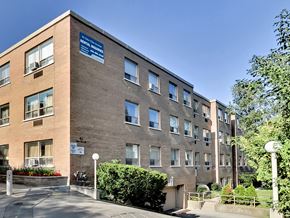 Toronto apartment for rent - A hospital building with a blue sign on the side.