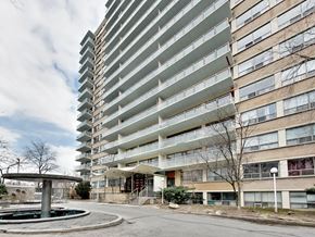 Toronto apartment for rent - A tall residential building with a pool in front.