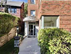 Toronto apartment for rent - A brick building with a white awning and a glass door.