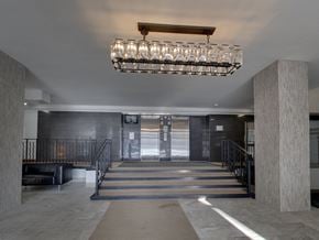 Toronto apartment for rent - a lobby with a staircase and a large chandelier