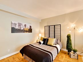 Toronto apartment for rent - a bedroom with a bed and a painting on the wall