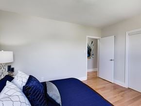 Toronto apartment for rent - A bedroom with a bed and a lamp.