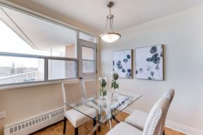 Toronto apartment for rent - A dining room with a glass table and chairs.
