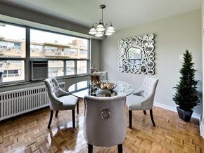 Toronto apartment for rent - a dining room with a table and chairs and a window