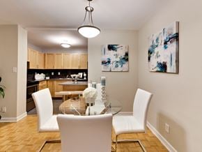 Toronto apartment for rent - a dining room with white chairs and a glass table